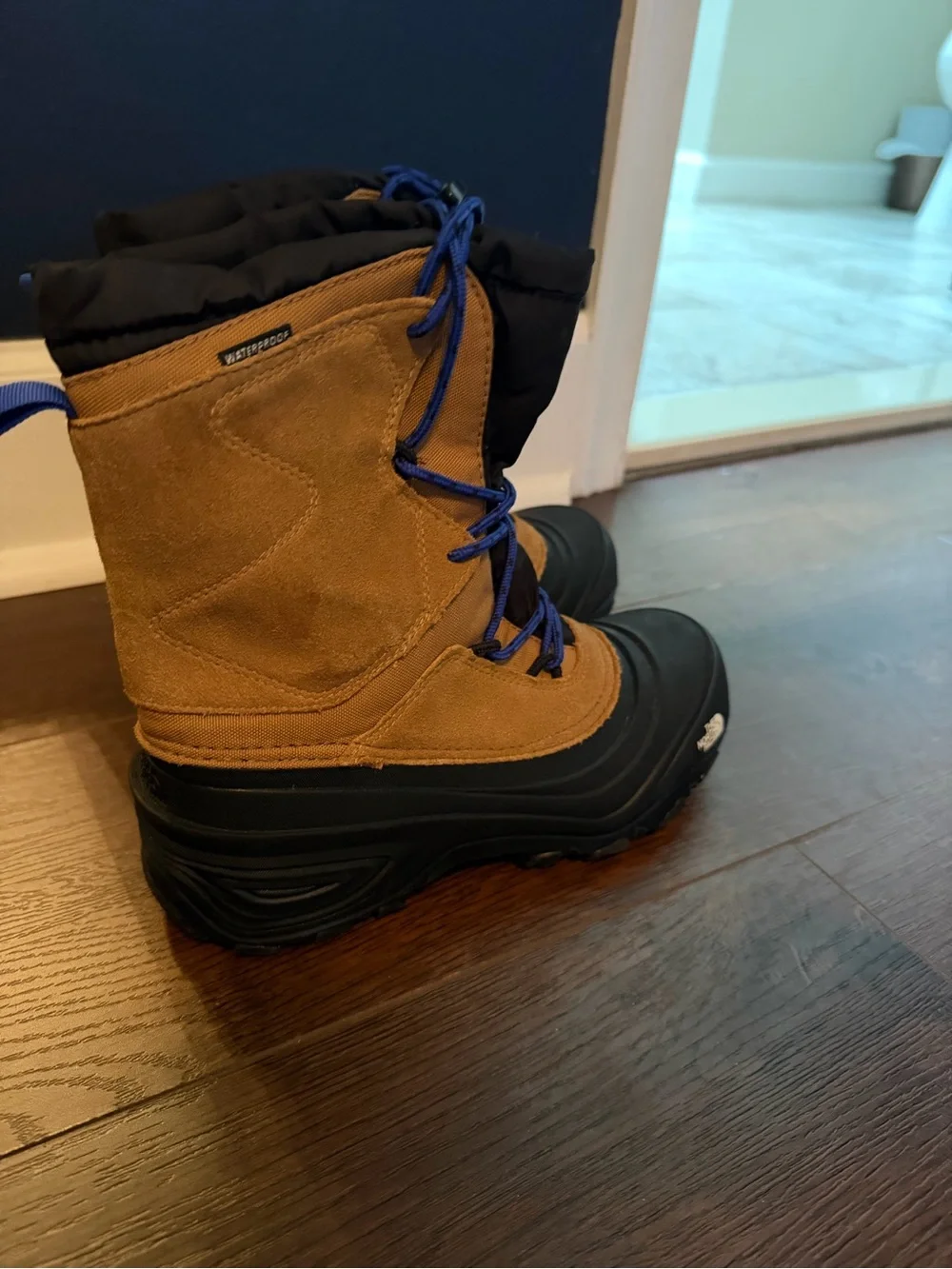 The North Face Kids Brown and Black Waterproof Snow Boots with Blue Laces